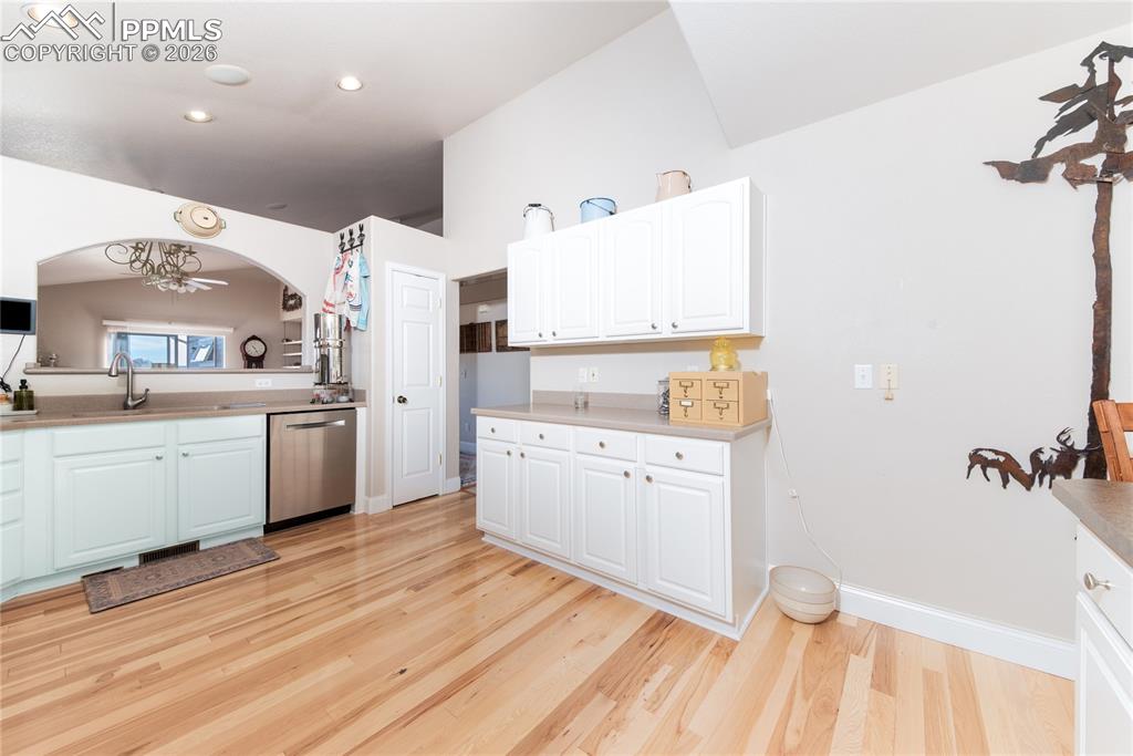 9385 Winged Foot Road Peyton, CO 80831 - Photo 6 of 50 a room with a white bed and a cabinets