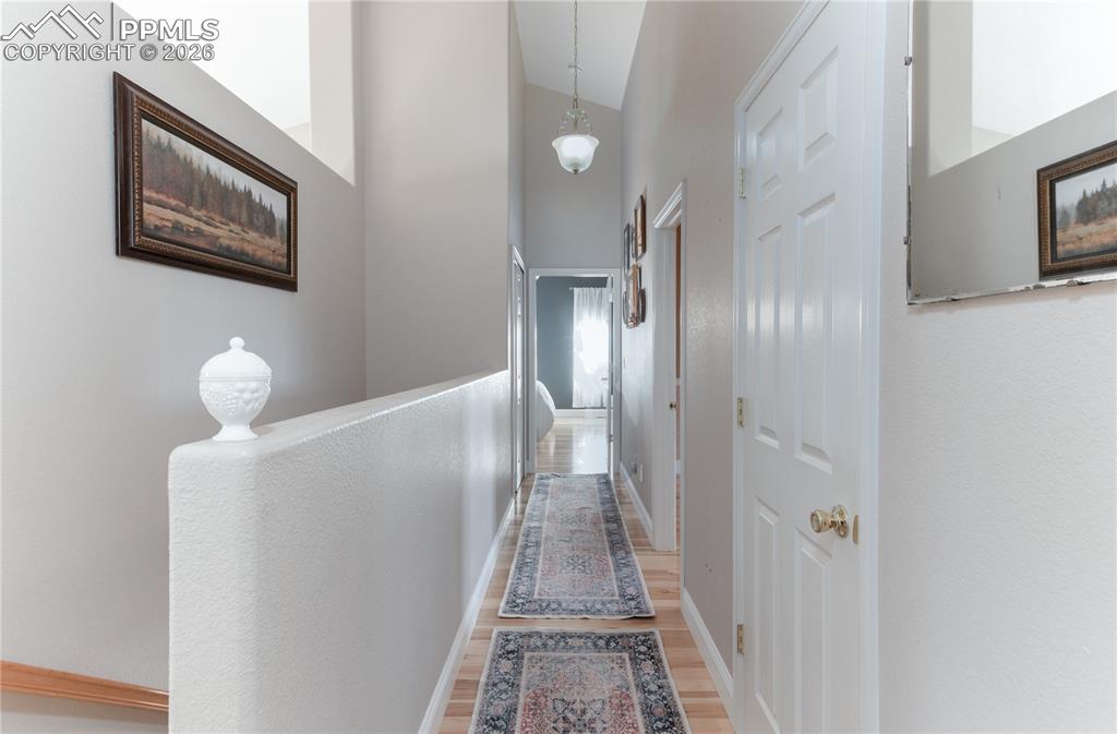 9385 Winged Foot Road Peyton, CO 80831 - Photo 9 of 50 a view of a hallway with wooden floor and staircase