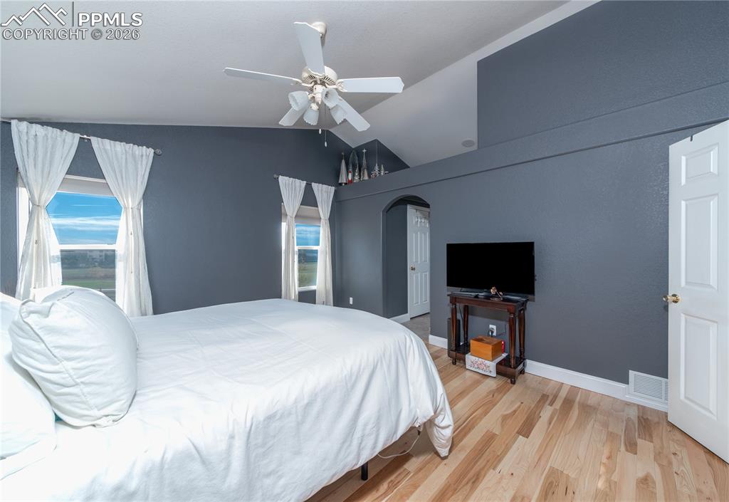 9385 Winged Foot Road Peyton, CO 80831 - Photo 10 of 50 a bedroom with a bed and a flat screen tv