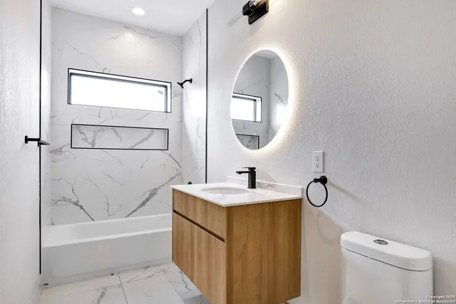 a bathroom with a sink a toilet and bathtub