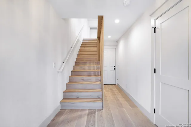 a view of entryway and hall with wooden floor