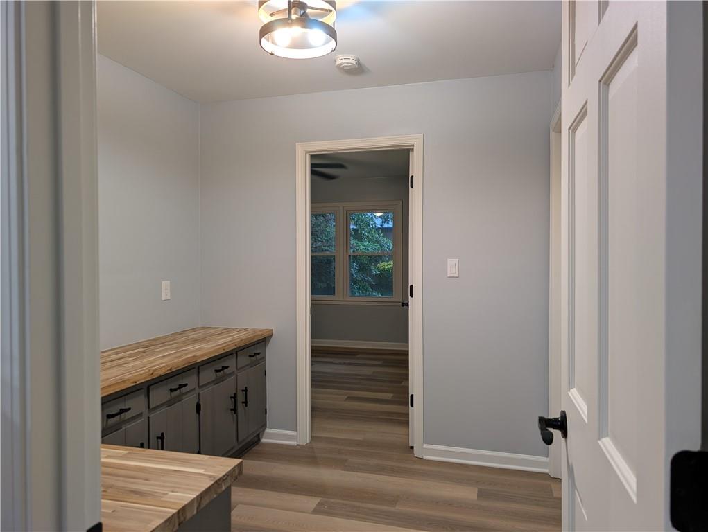 402 Pheasant Run Rome, GA 30161 - Photo 46 of 74 a view of a hallway with wooden floor and staircase