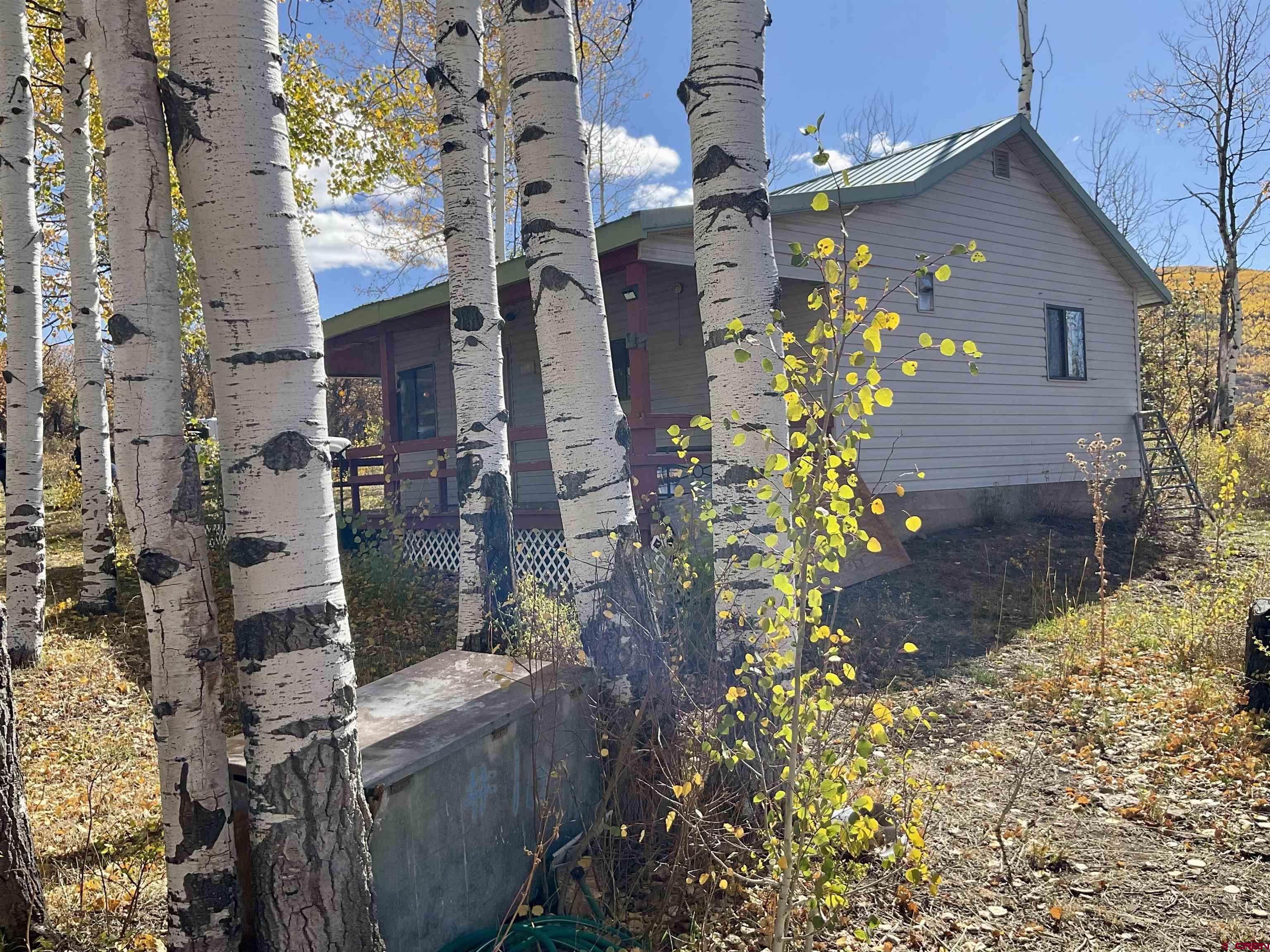 20261 3100th Road Hotchkiss, CO 81419 - Photo 17 of 41 a front view of a house with a yard