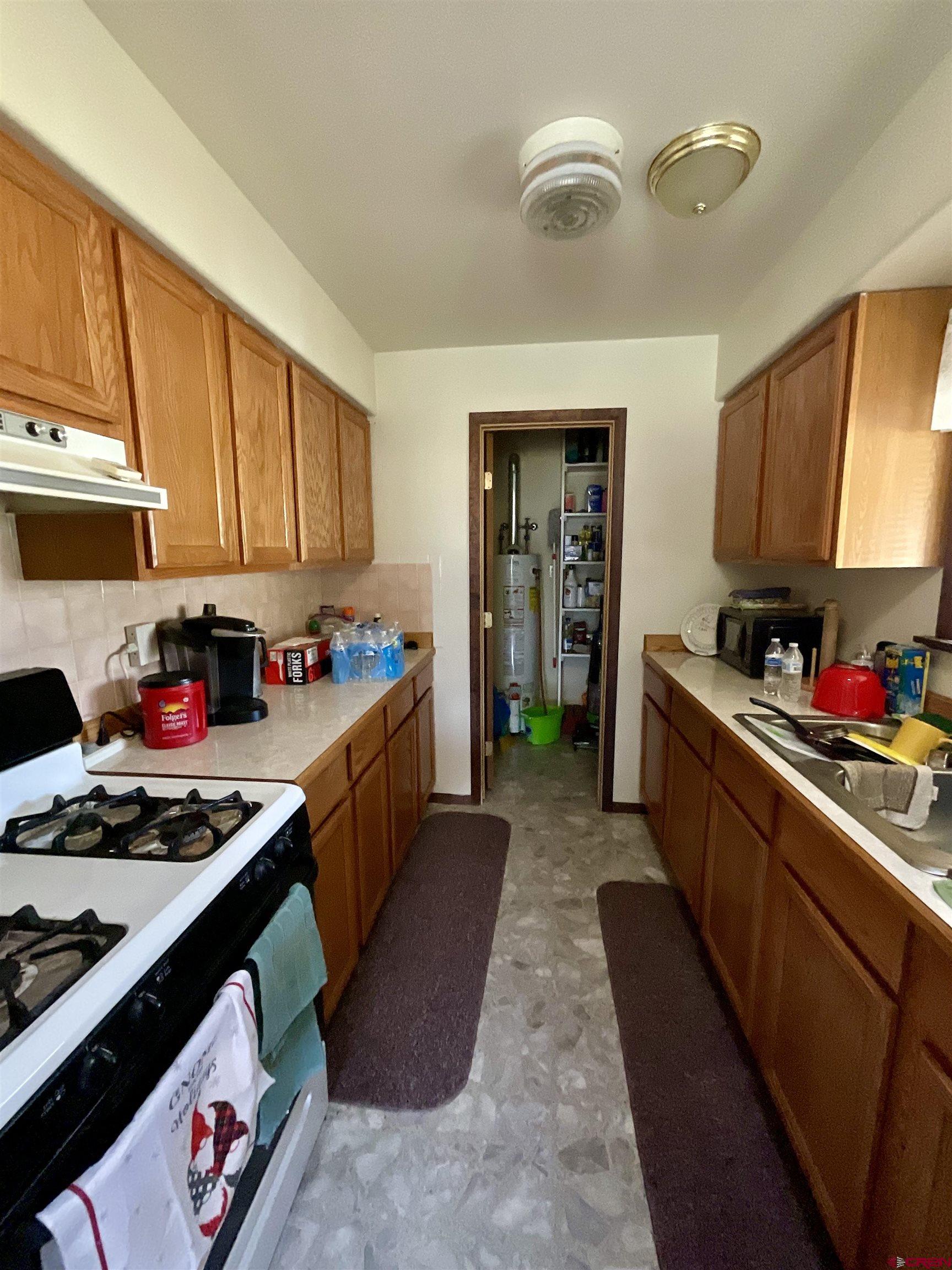 20261 3100th Road Hotchkiss, CO 81419 - Photo 7 of 41 a kitchen with sink cabinets and stove top oven
