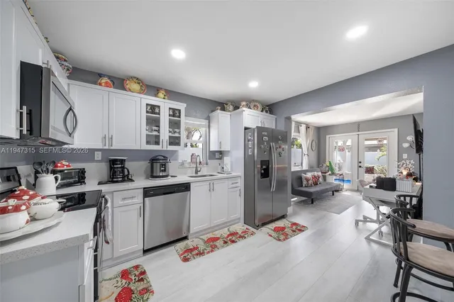 a bedroom with a bed and a flat tv screen on dresser