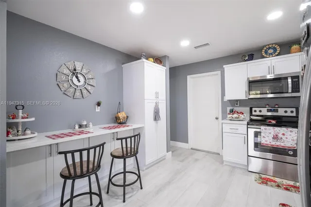 a bed room with a bed and a chandelier