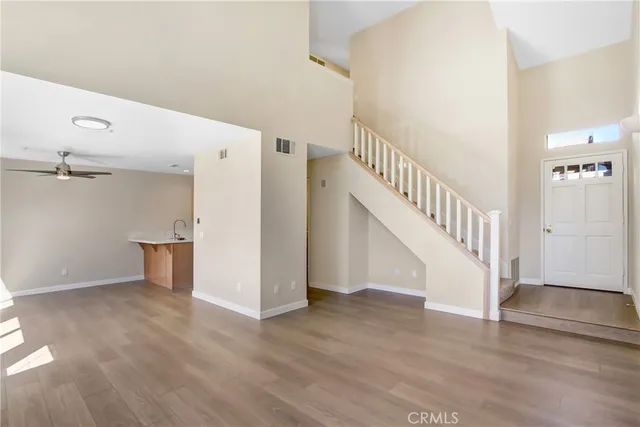 a view of entryway and hall with wooden floor
