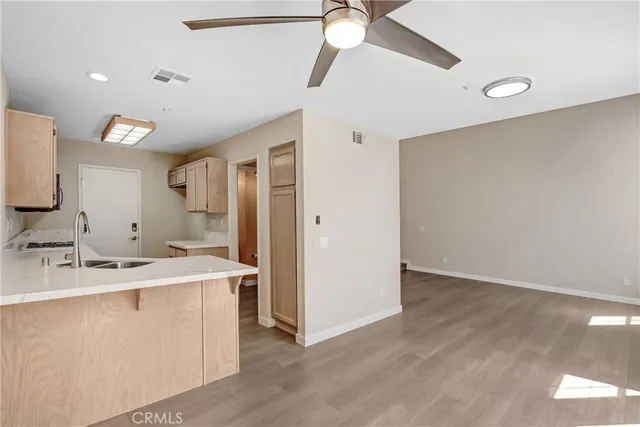 a view of a kitchen with a sink and a refrigerator