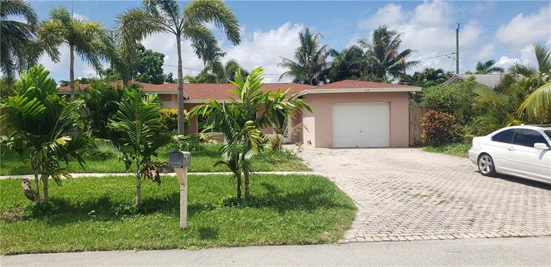 98 Seminole Lane Boca Raton, FL 33487 - Photo 2 of 42 a white house with a yard plants and palm trees