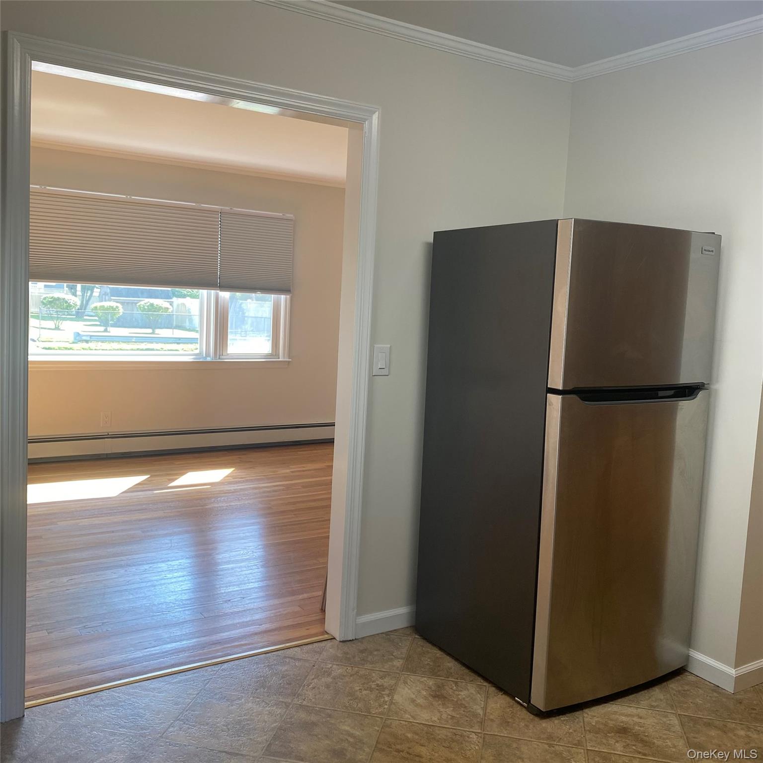 282 Laurel Road, Unit A East Northport, NY 11731 - Photo 6 of 20 a view of water heater room with wooden floor and a window