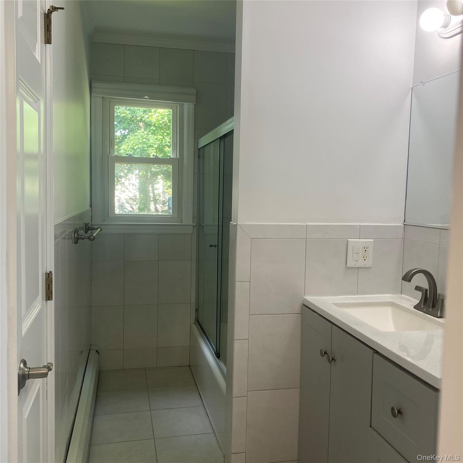 282 Laurel Road, Unit A East Northport, NY 11731 - Photo 10 of 20 a bathroom with a sink toilet and tub