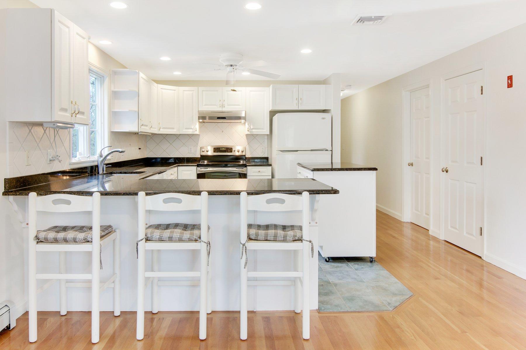 230 Chippingstone Road Chatham, MA 02633 - Photo 20 of 38 a kitchen with stainless steel appliances granite countertop a stove a sink and a refrigerator