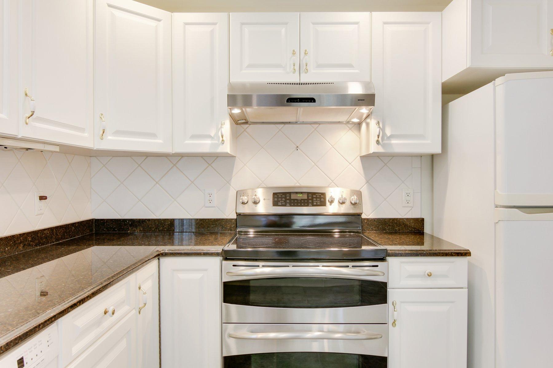 230 Chippingstone Road Chatham, MA 02633 - Photo 23 of 38 a stove top oven sitting inside of a kitchen