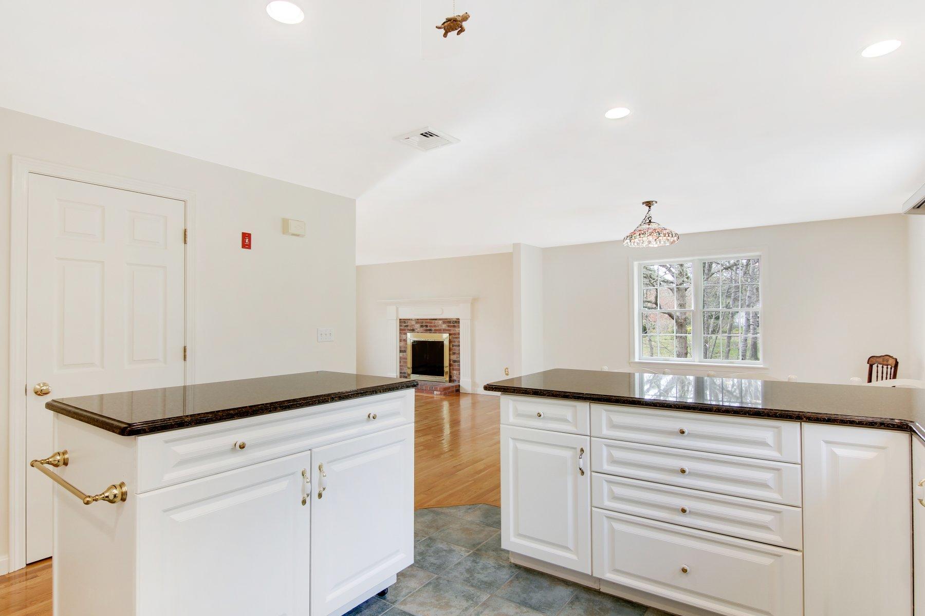 230 Chippingstone Road Chatham, MA 02633 - Photo 24 of 38 a kitchen with granite countertop white cabinets and white appliances