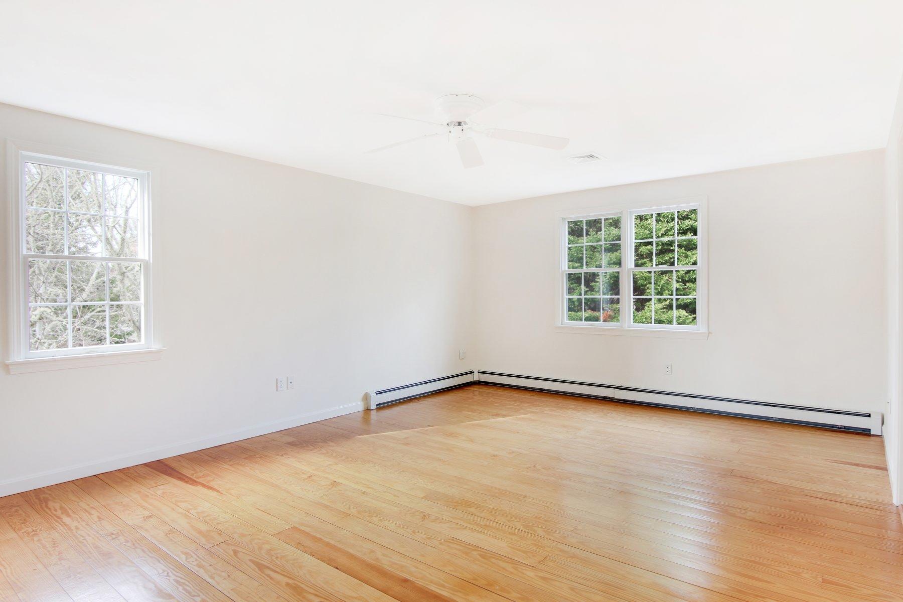 230 Chippingstone Road Chatham, MA 02633 - Photo 29 of 38 an empty room with wooden floor and windows
