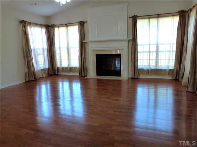 7500 Lagrange Drive Raleigh, NC 27613 - Photo 3 of 20 a view of an empty room with wooden floor and a window