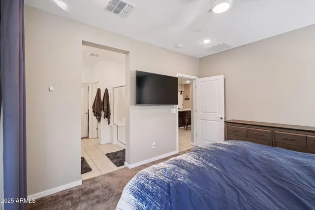 a bedroom with a bed and a television in it
