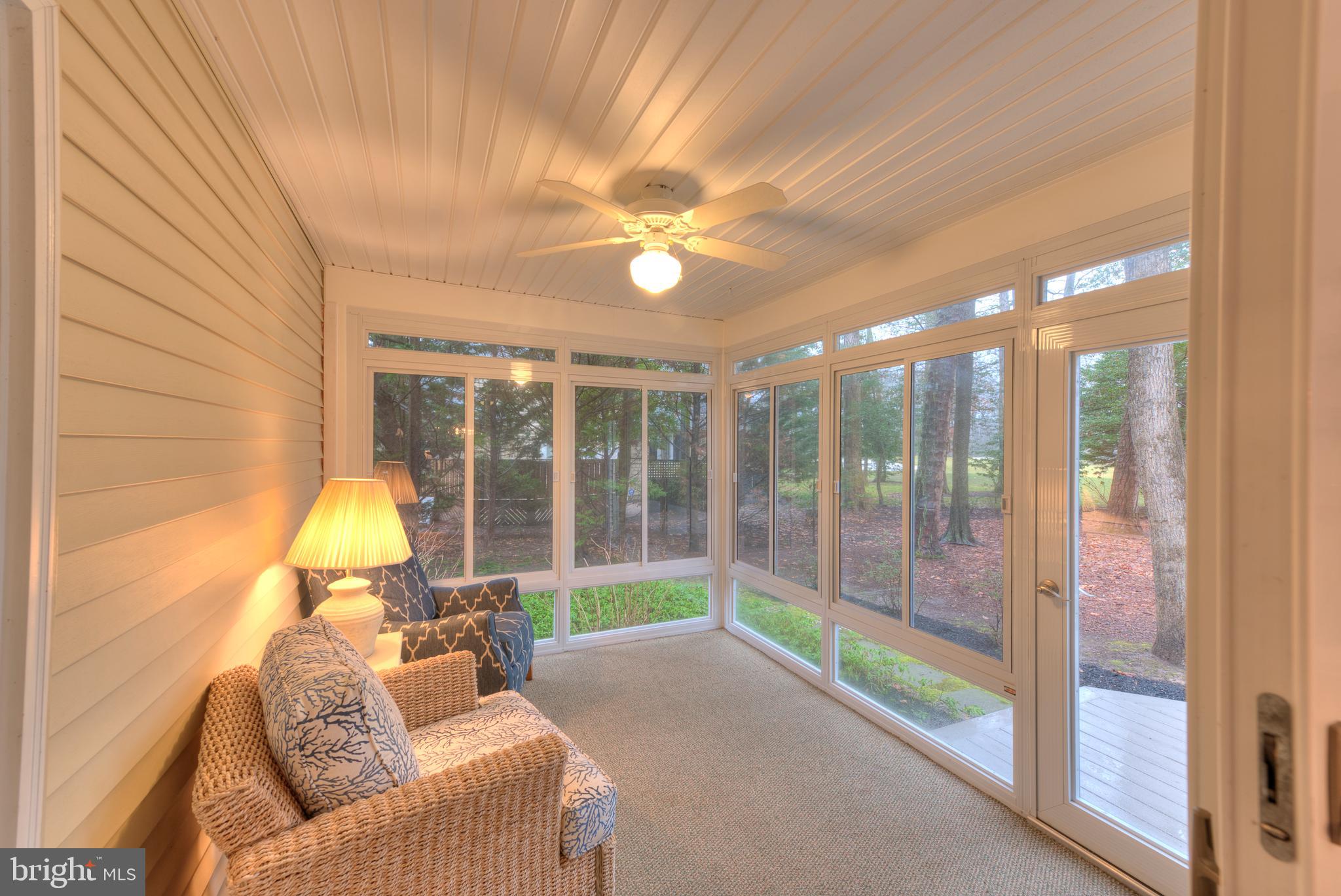 9 Wolfpit Court Rehoboth Beach, DE 19971 - Photo 16 of 31 3 season porch off overlooks back yard and hole #7