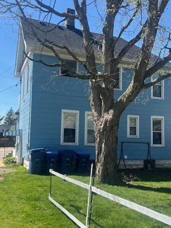 a view of house with a yard