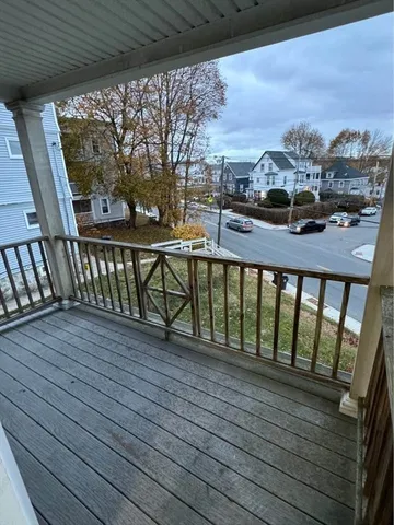 a view of a balcony with wooden floor