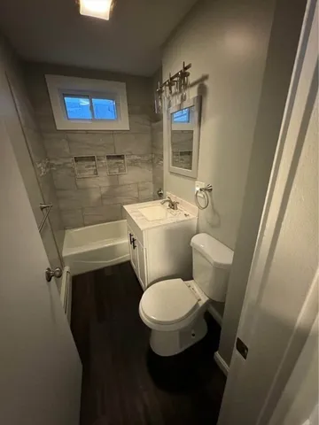 a white toilet sitting next to a bathroom sink