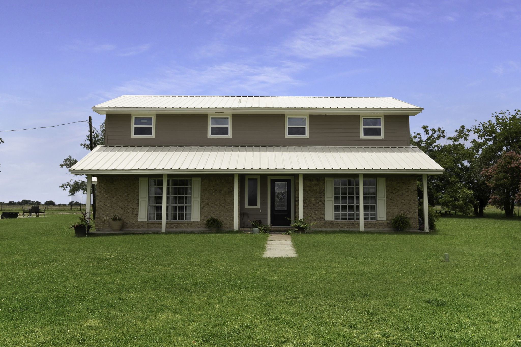 a view of a house with a yard and sitting area