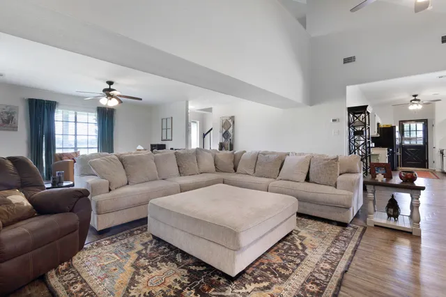 a living room with furniture and a wooden floor