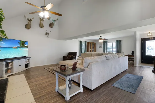 a living room with furniture and a chandelier