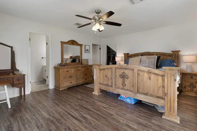 a living room with furniture and view of kitchen