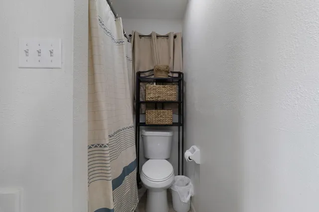 a bathroom with a toilet and a shower