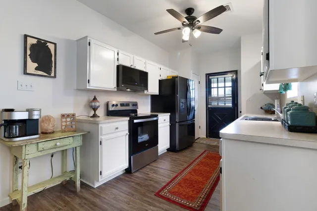 a kitchen with a stove a sink and a refrigerator