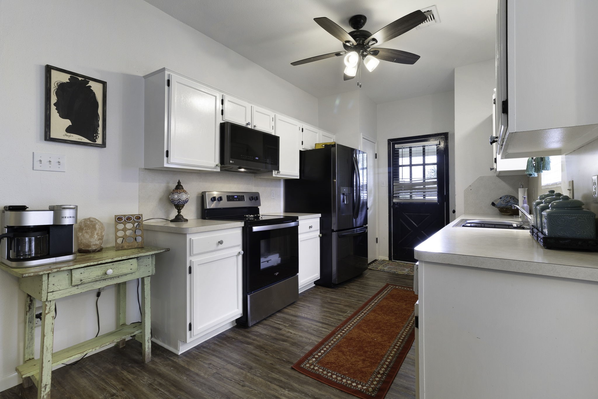 8043 Bell Lane Midway, TX 75852 - Photo 22 of 40 a kitchen with a stove a sink and a refrigerator