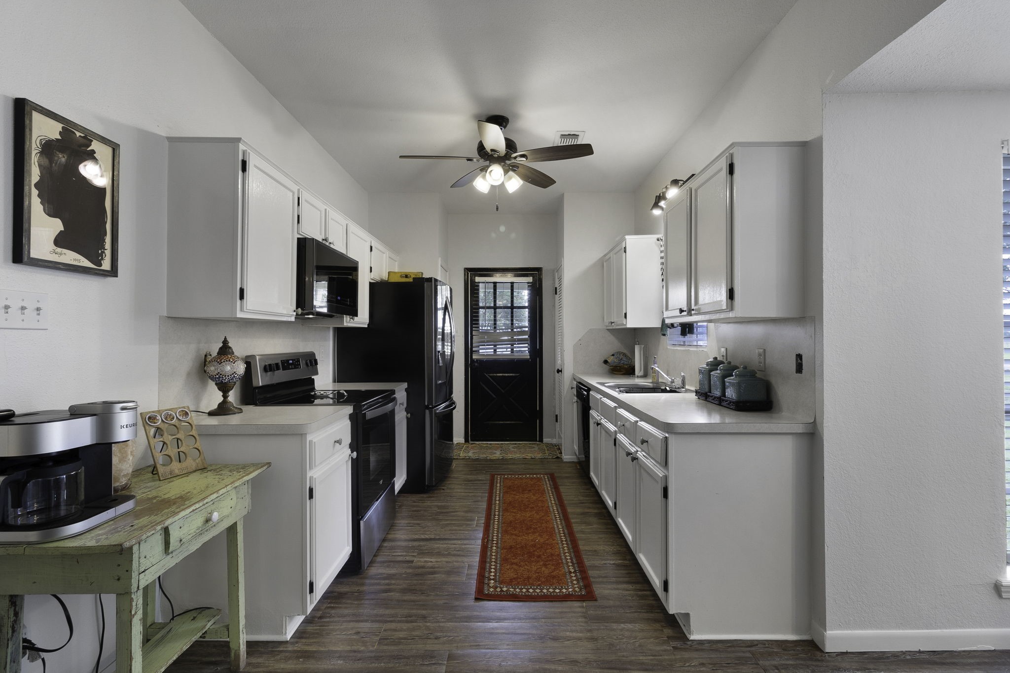8043 Bell Lane Midway, TX 75852 - Photo 23 of 40 a kitchen with kitchen island granite countertop a sink cabinets and stainless steel appliances