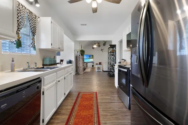 a kitchen with stainless steel appliances a refrigerator and a sink