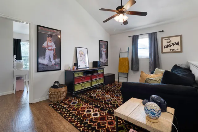 a living room with furniture and wooden floor