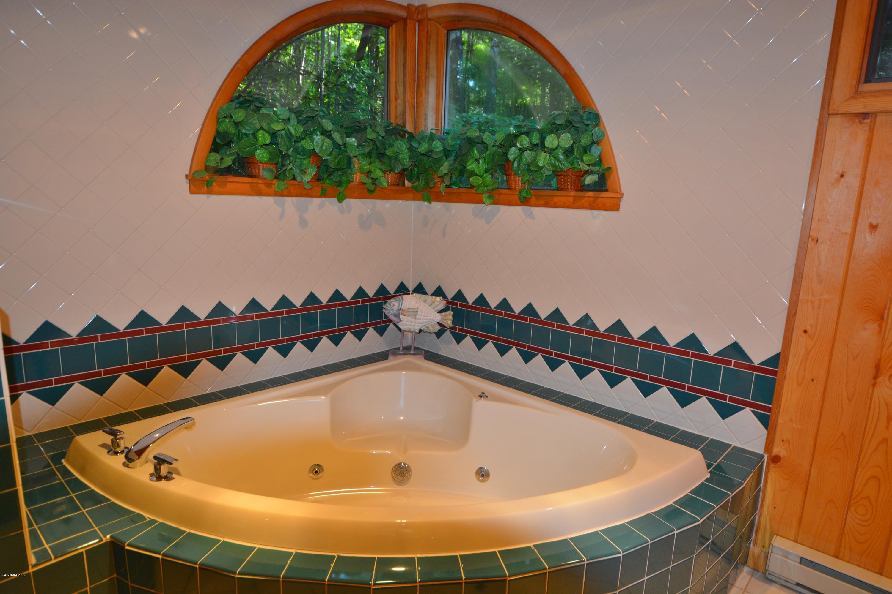 531 Moberg Road Becket, MA 01223 - Photo 12 of 25 a bathroom with a tub and mirror