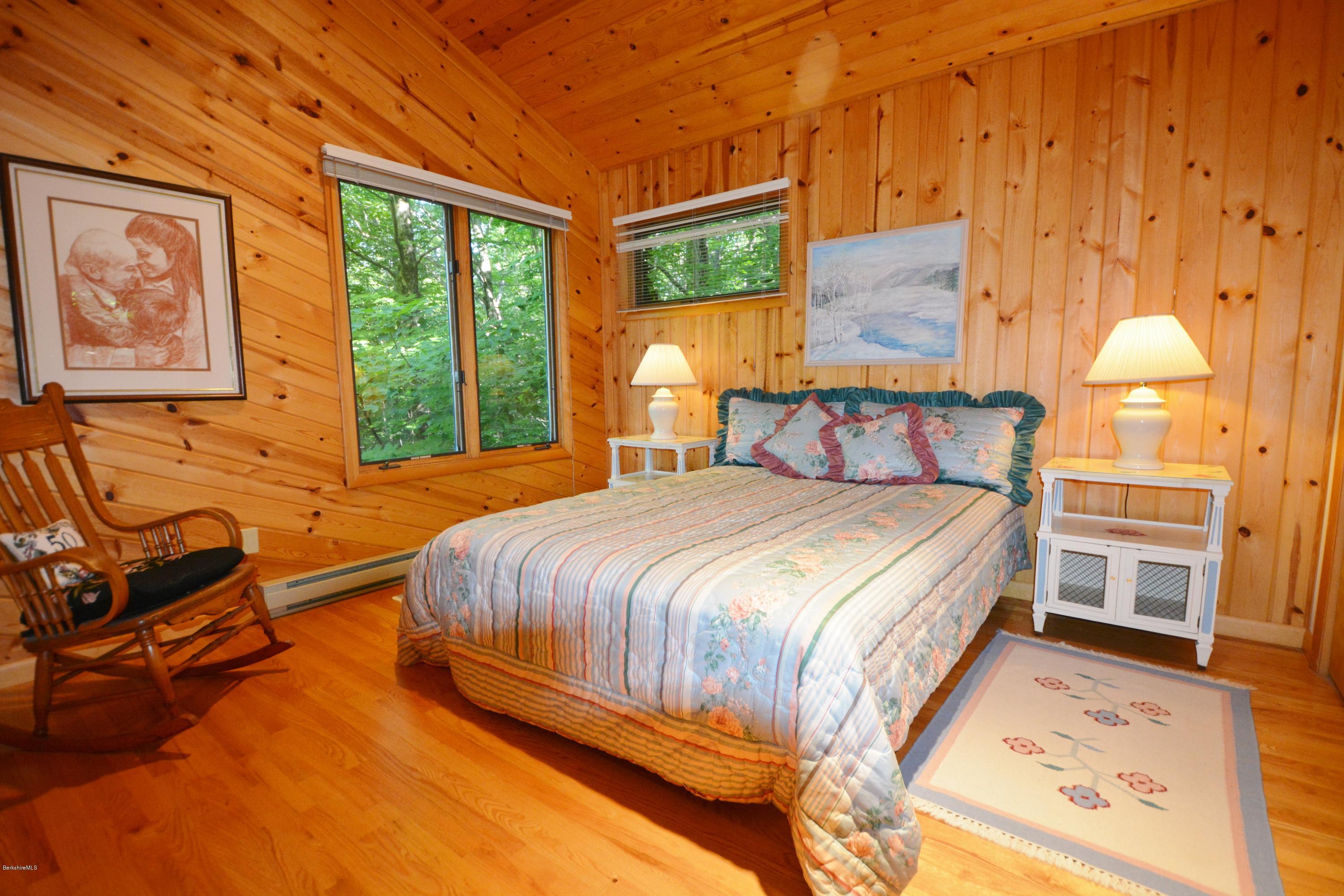 531 Moberg Road Becket, MA 01223 - Photo 17 of 25 a bedroom with a bed and wooden floor