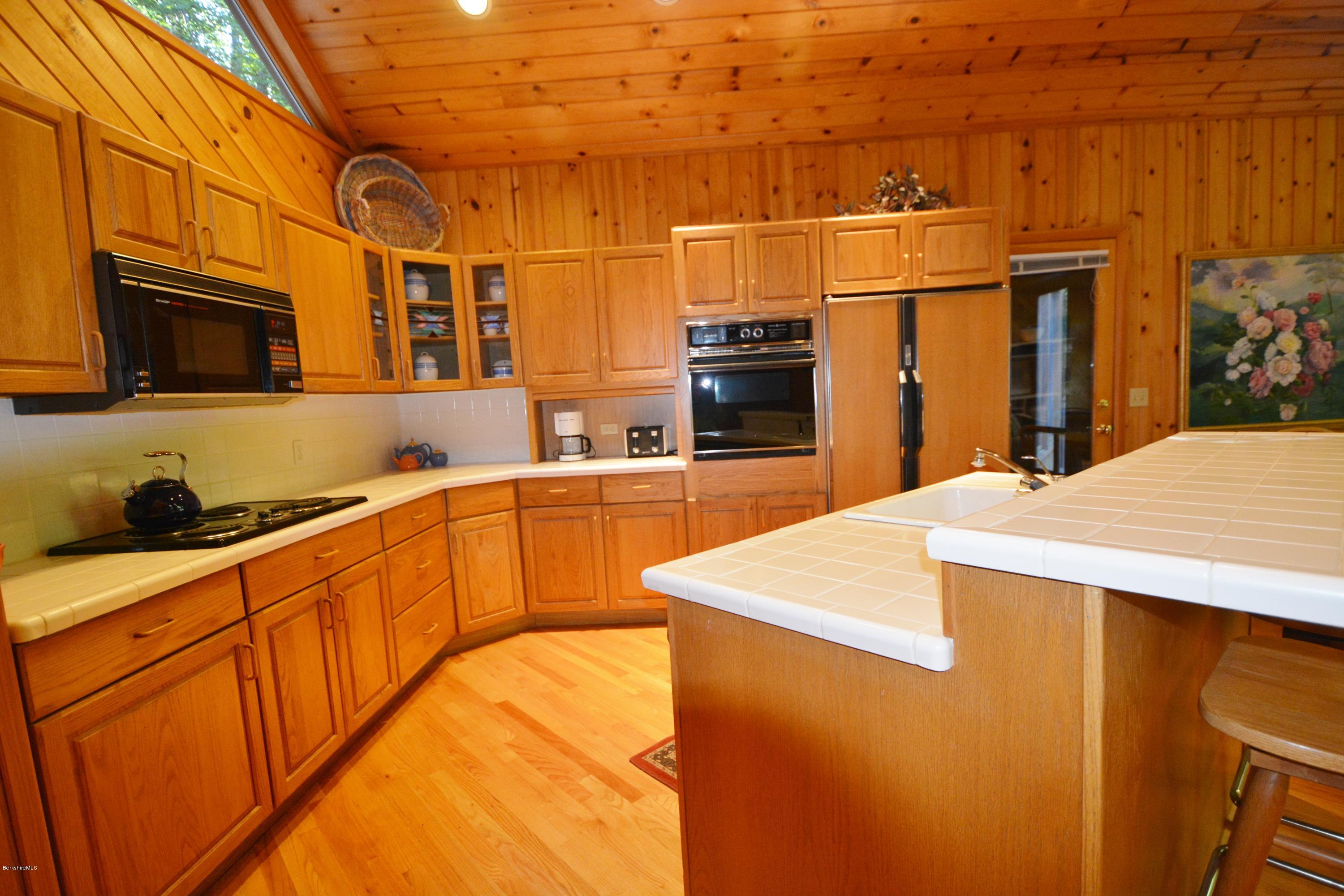531 Moberg Road Becket, MA 01223 - Photo 7 of 25 a view of a kitchen with stainless steel appliances wooden cabinets and a sink