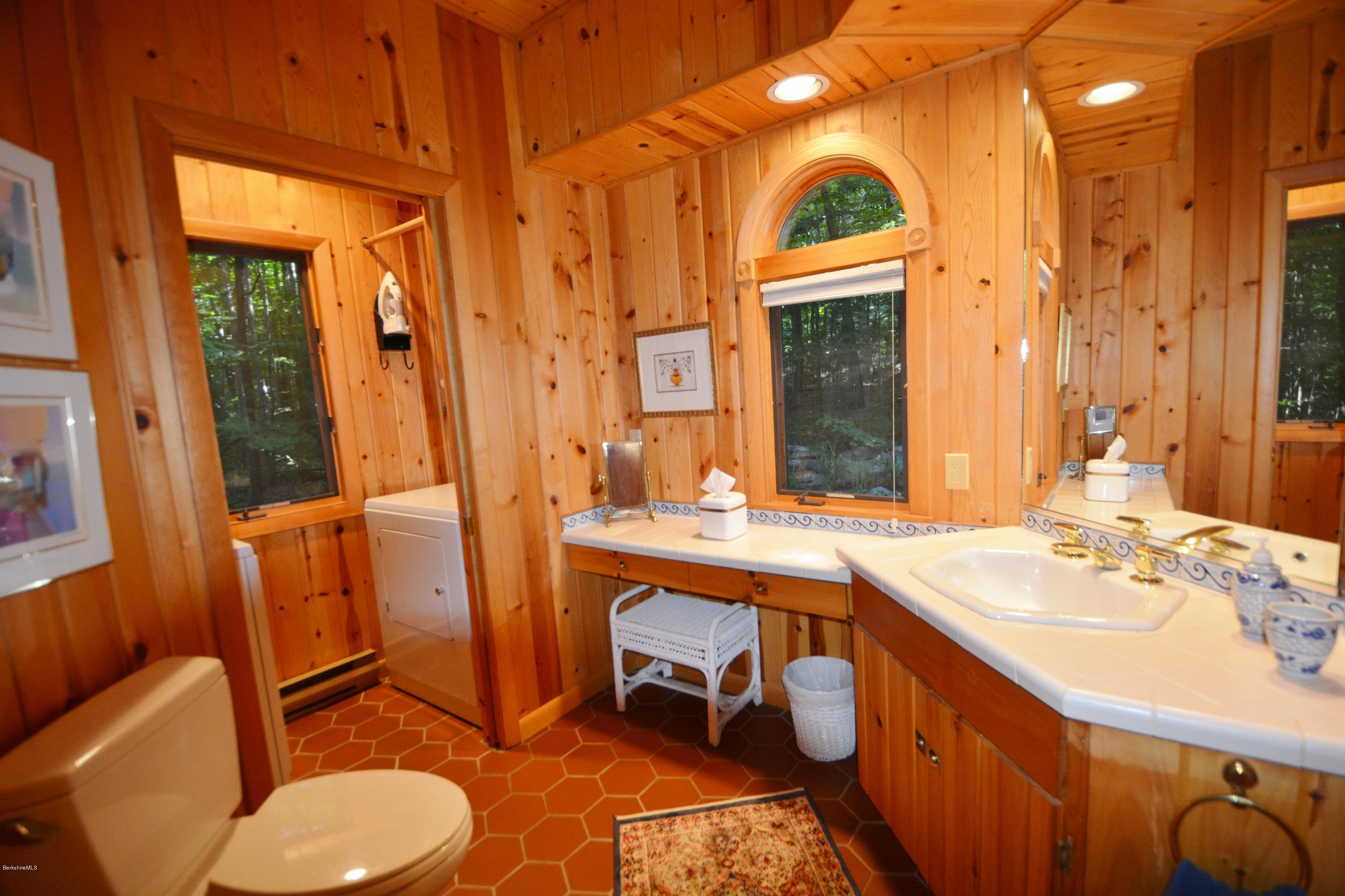 531 Moberg Road Becket, MA 01223 - Photo 9 of 25 a bathroom with a sink a toilet a mirror and shower