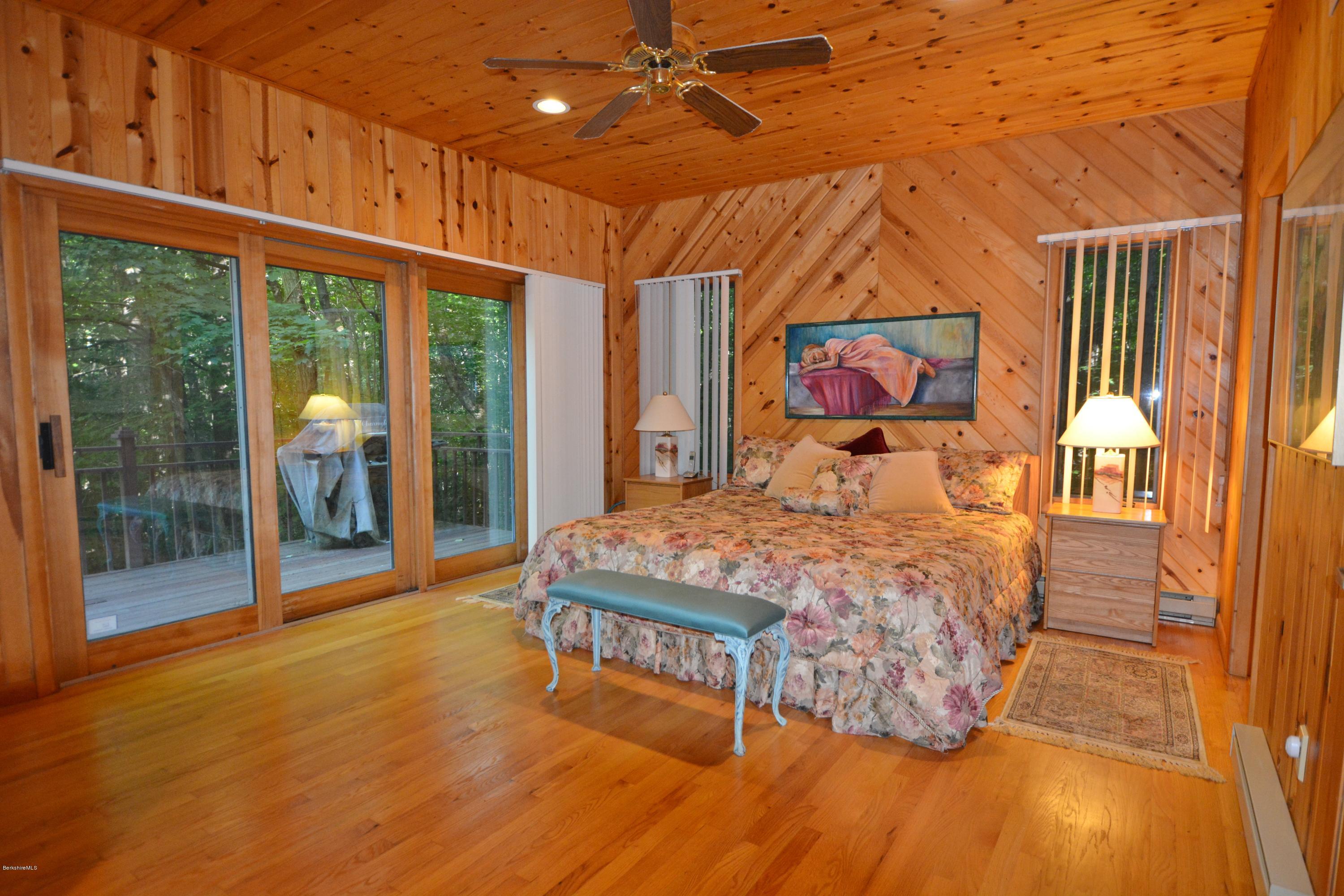 531 Moberg Road Becket, MA 01223 - Photo 10 of 25 a bedroom with a bed and wooden floor