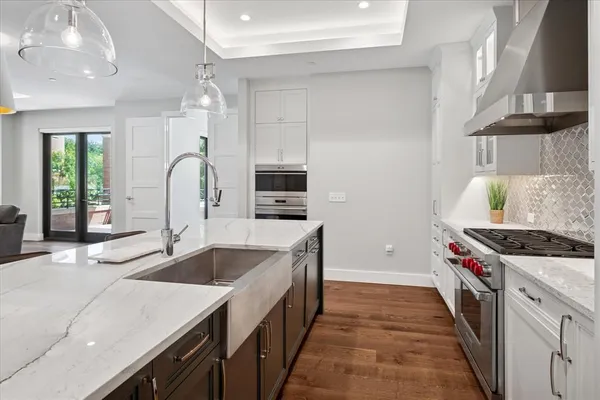 a kitchen with stainless steel appliances granite countertop a sink stove and refrigerator