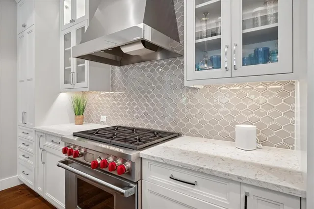 a kitchen with stainless steel appliances granite countertop a stove and a microwave