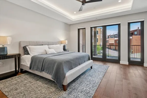 a bedroom with a large bed and a night stand