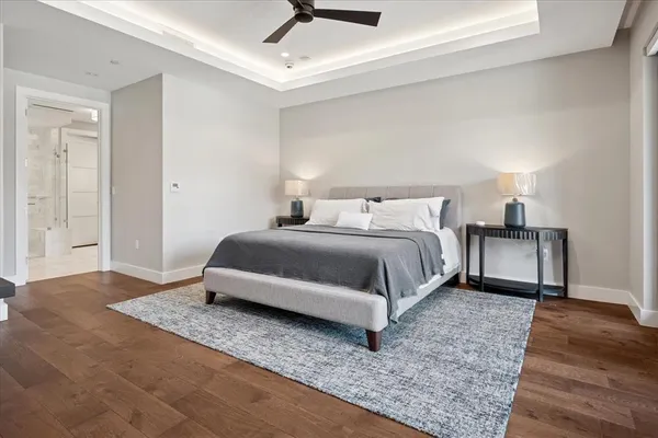 a bedroom with a bed and wooden floor