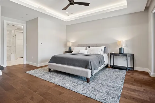 a bedroom with a bed and wooden floor
