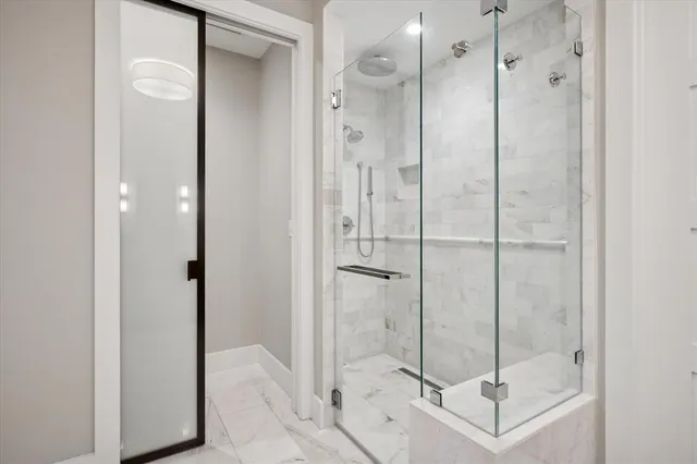 a bathroom with a shower and a sink