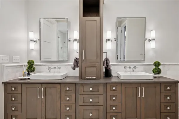 a bathroom with a double vanity sink and a