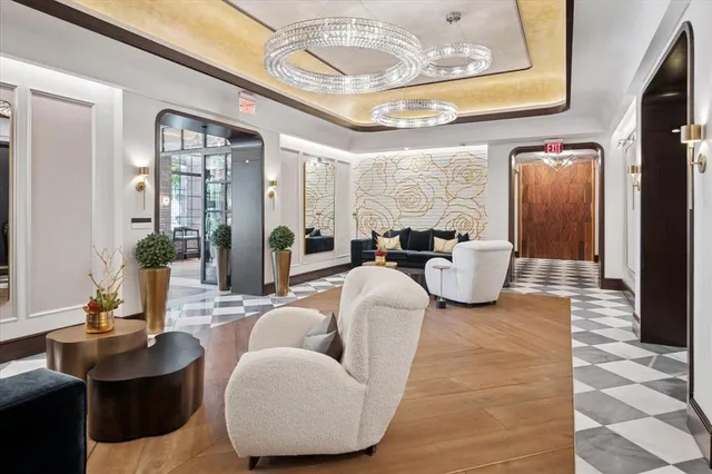 a living room with furniture and a chandelier