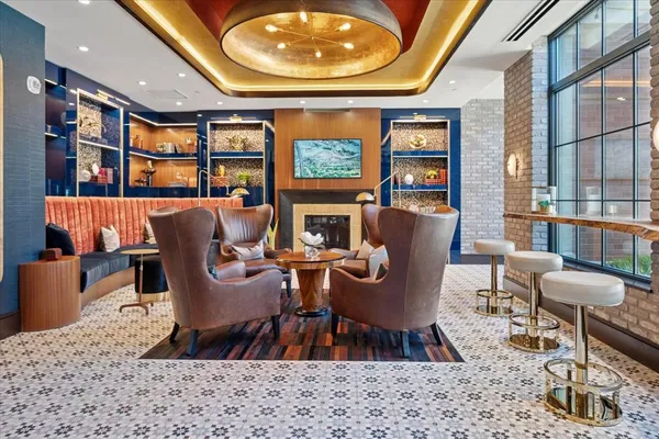 a living room with furniture a rug and a large window