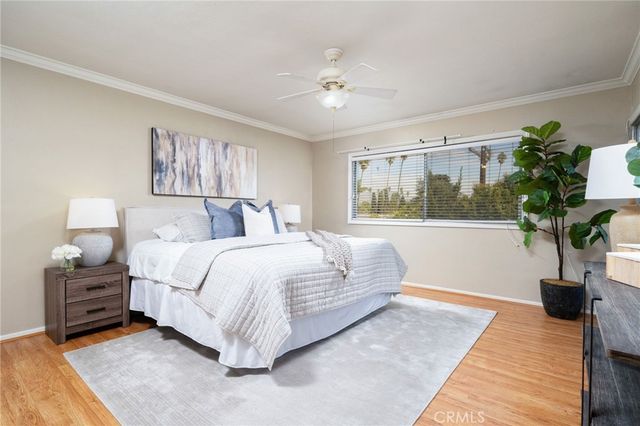 a bedroom with a large bed and a chandelier